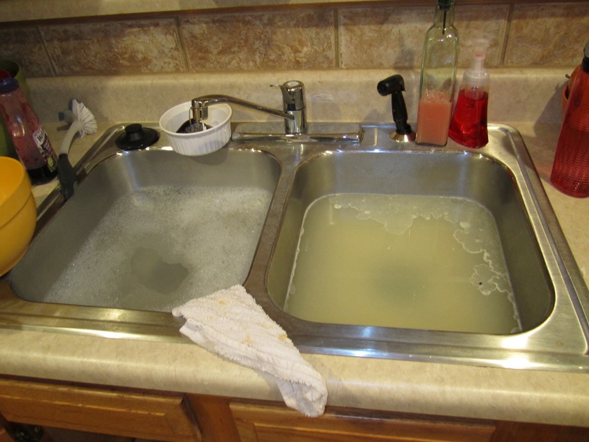 kitchen sink clogged into bathroom