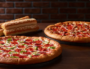 2 Large Pizzas + 2 Sides+1.25 L Drink + 1 HERSHEY'S Cookie $34.95 Pickup or $36.95 Delivered